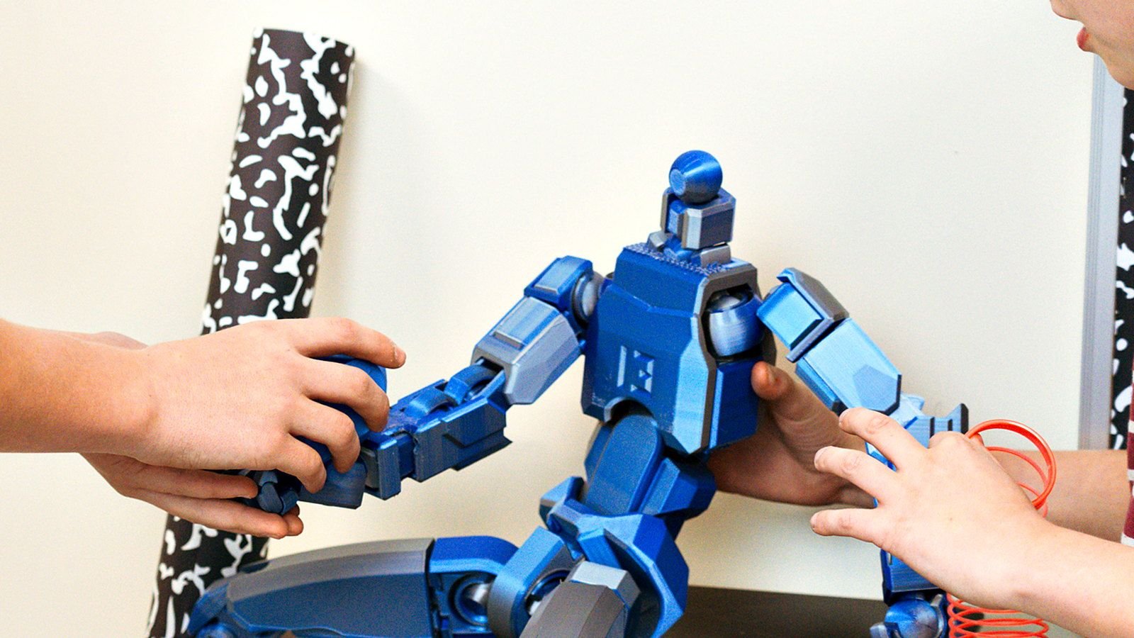 A student and teacher at Goodwin Learning Academy assembling a robotics build together